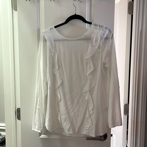 Lightweight long sleeve blouse with ruffle detail on front.